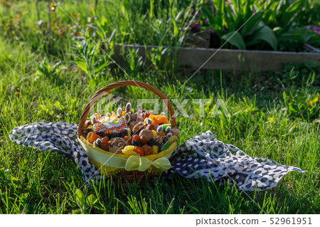 Basket with Easter cake, dried fruits and nuts Basket with Easter cake, dried fruits and nuts 52961951