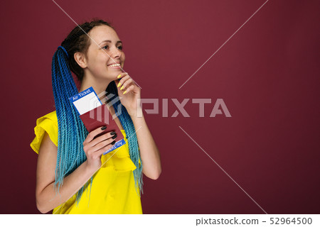 A modern trendy smiling woman in yellow dress with 52964500