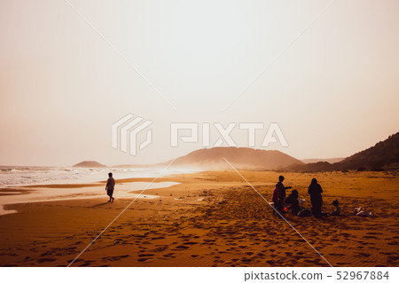People Silhouettes playing in sandy Golden Beach 52967884