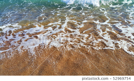 Clear sea water with white foam in the coastal Clear sea water with white foam in the coastal 52969754