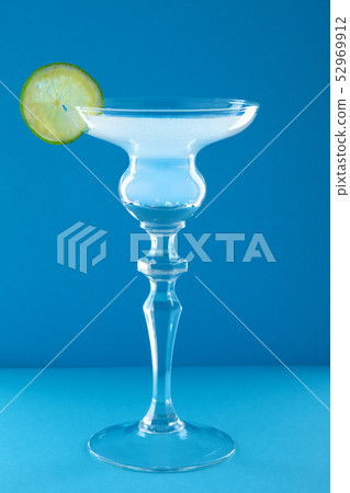 Gin tonic cocktail on blue background Gin tonic cocktail on blue background 52969912