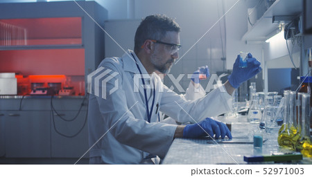 Scientist working at laboratory Scientist working at laboratory 52971003
