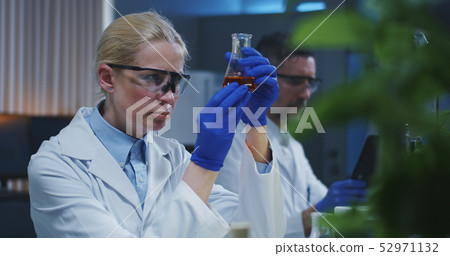 Scientists examining liquid Scientists examining liquid 52971132
