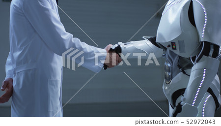 Man and robot shaking hands Man and robot shaking hands 52972043