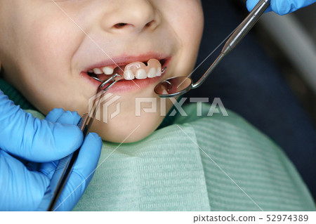 Little girl at dentist on examination. Little girl at dentist on examination. 52974389