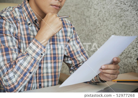 Businessman reading contract Businessman reading contract 52977268