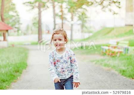little girl joyful on the street 52979816