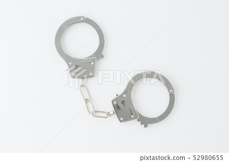 Police criminal drama to grab handcuffs of toy on white background Police criminal drama to grab handcuffs of toy on white background 52980655