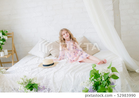 little girl with blond hair with lilac flowers 52983990