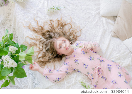 little girl with blond hair with lilac flowers 52984044