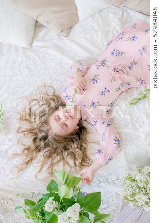 little girl with blond hair with lilac flowers 52984048