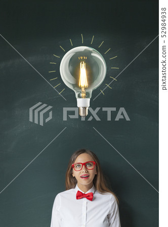 Light Bulb and Young Woman on Blackboard Light Bulb and Young Woman on Blackboard 52984938