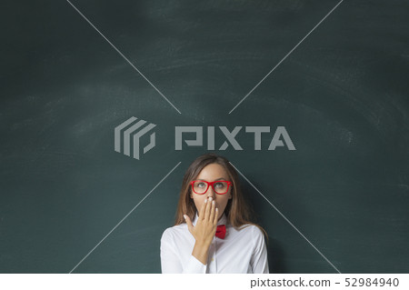 Young woman looking up with blackboard 52984940