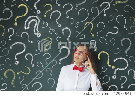 Young woman thinking with blackboard 52984941