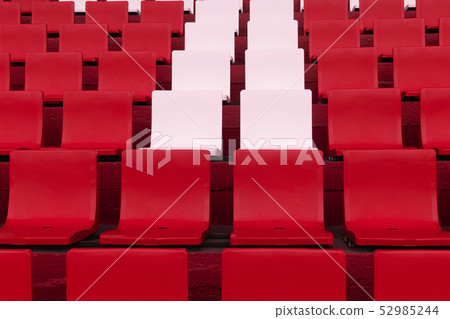 row of pink chair among red in soccer stadium 52985244