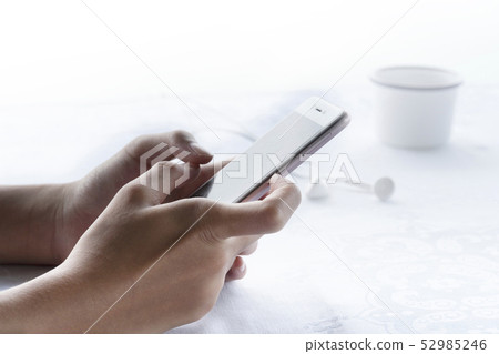 woman hang holding cellphone in morning breakfast woman hang holding cellphone in morning breakfast 52985246