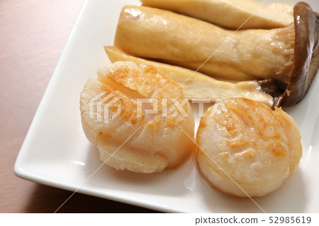 Butter grilled scallops. Eringhi to garnish. 52985619