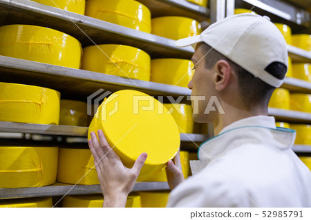 Portrait of inspector standing in production department of dairy factory and take view of redy Portrait of inspector standing in production department of dairy factory and take view of redy 52985791