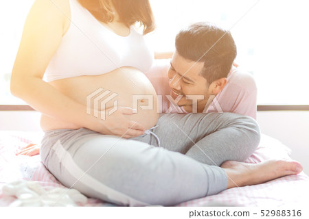 Asian pregnant woman. Mom and newborn baby. Asian pregnant woman. Mom and newborn baby. 52988316