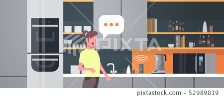 housewife using smart speaker voice recognition activated digital assistants automated command 52989819