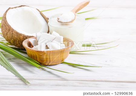 Coconut shell hard oil in glass jar and coconut Coconut shell hard oil in glass jar and coconut 52990636