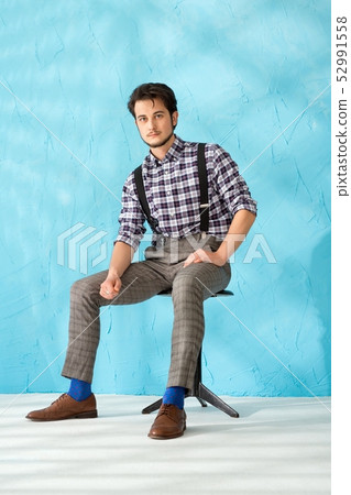 Young man in shirt and vest against blue back 52991558