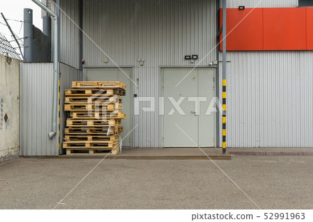 used pallets near the door of the store 52991963