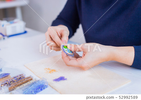 Designer making handmade brooch 52992589