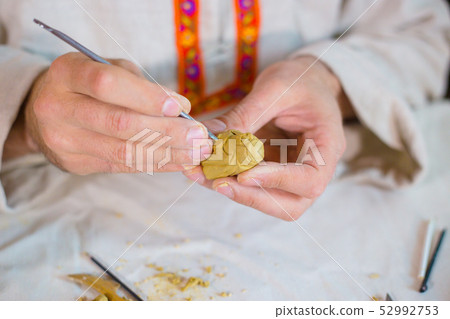 Potter making clay figure for board game 52992753