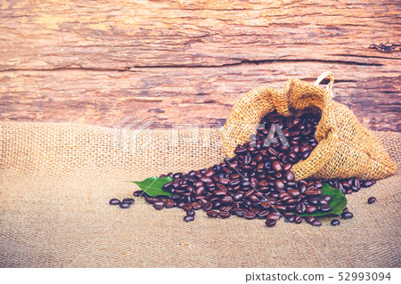 coffee bean in sack bag on a old wooden background warm vintage tone picture coffee bean in sack bag on a old wooden background warm vintage tone picture 52993094