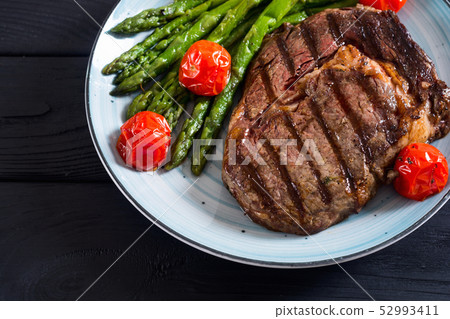 Grilled beef steak ribeye with cherry tomatoes and Grilled beef steak ribeye with cherry tomatoes and 52993411