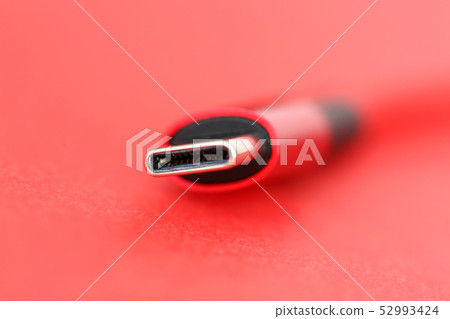 Red usb cable end lying on table 52993424
