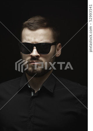 Portrait of Man in Black Indoors 52993541