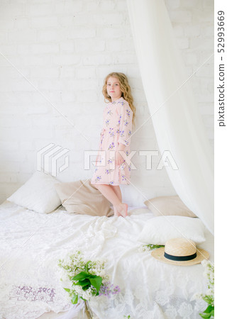 little girl with blond hair with lilac flowers 52993669
