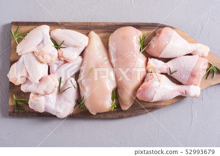 Raw chicken meat on wooden background Raw chicken meat on wooden background 52993679
