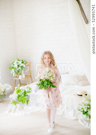 little girl with blond hair with lilac flowers 52993741