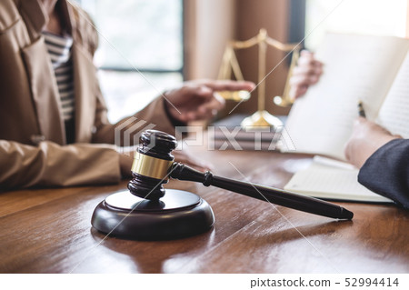 Businesswoman and Male lawyer or judge consult Businesswoman and Male lawyer or judge consult 52994414
