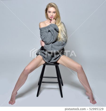 barefoot woman in sweater in studio 52995129