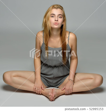 beautiful woman in short overall is sitting on the 52995153