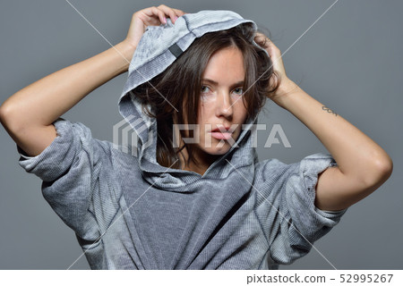 Portrait of the beautiful woman in grey hoody blouse. 52995267