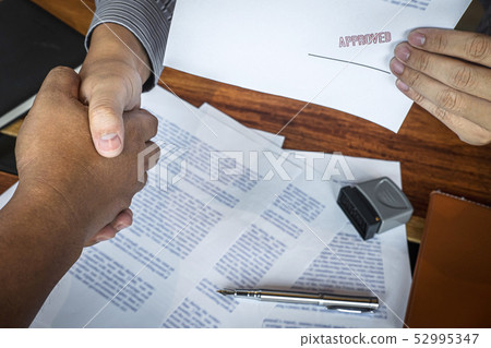 Hands of businessman shaking after to finish Hands of businessman shaking after to finish 52995347