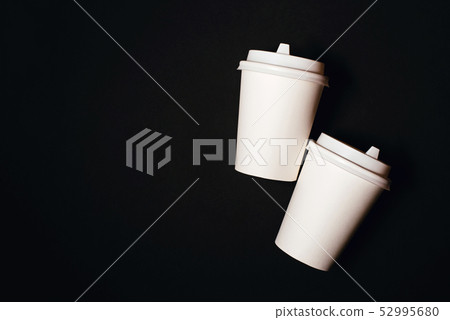 Two paper cups on black background Two paper cups on black background 52995680
