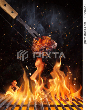 Chicken piece on the grill with flames 52996642