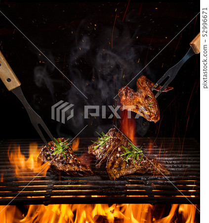 Beef steaks on the grill with flames 52996671