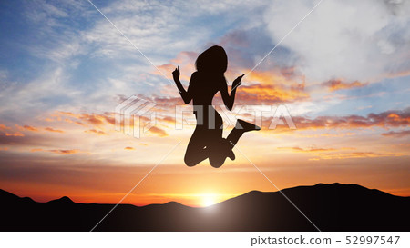 Silhouette of jumping woman against sunset background Silhouette of jumping woman against sunset background 52997547