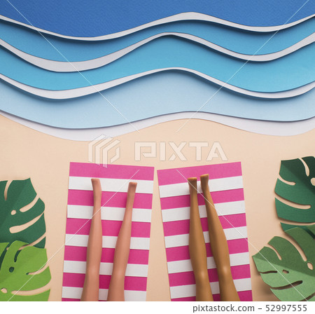 Summer background with women legs sunbasing near sea Summer background with women legs sunbasing near sea 52997555