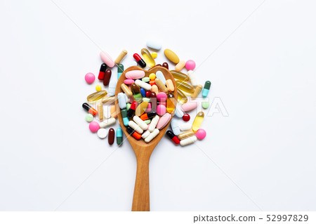 Colorful tablets with capsules and pills on white. 52997829