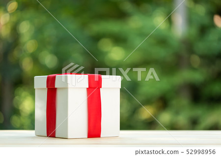 A gift box on forest background 52998956