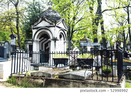 Tombstones in cemetery at dusk, gothic style crosses Paris Tombstones in cemetery at dusk, gothic style crosses Paris 52998992