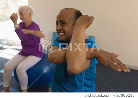 Senior man exercising in fitness studio Senior man exercising in fitness studio 53000285